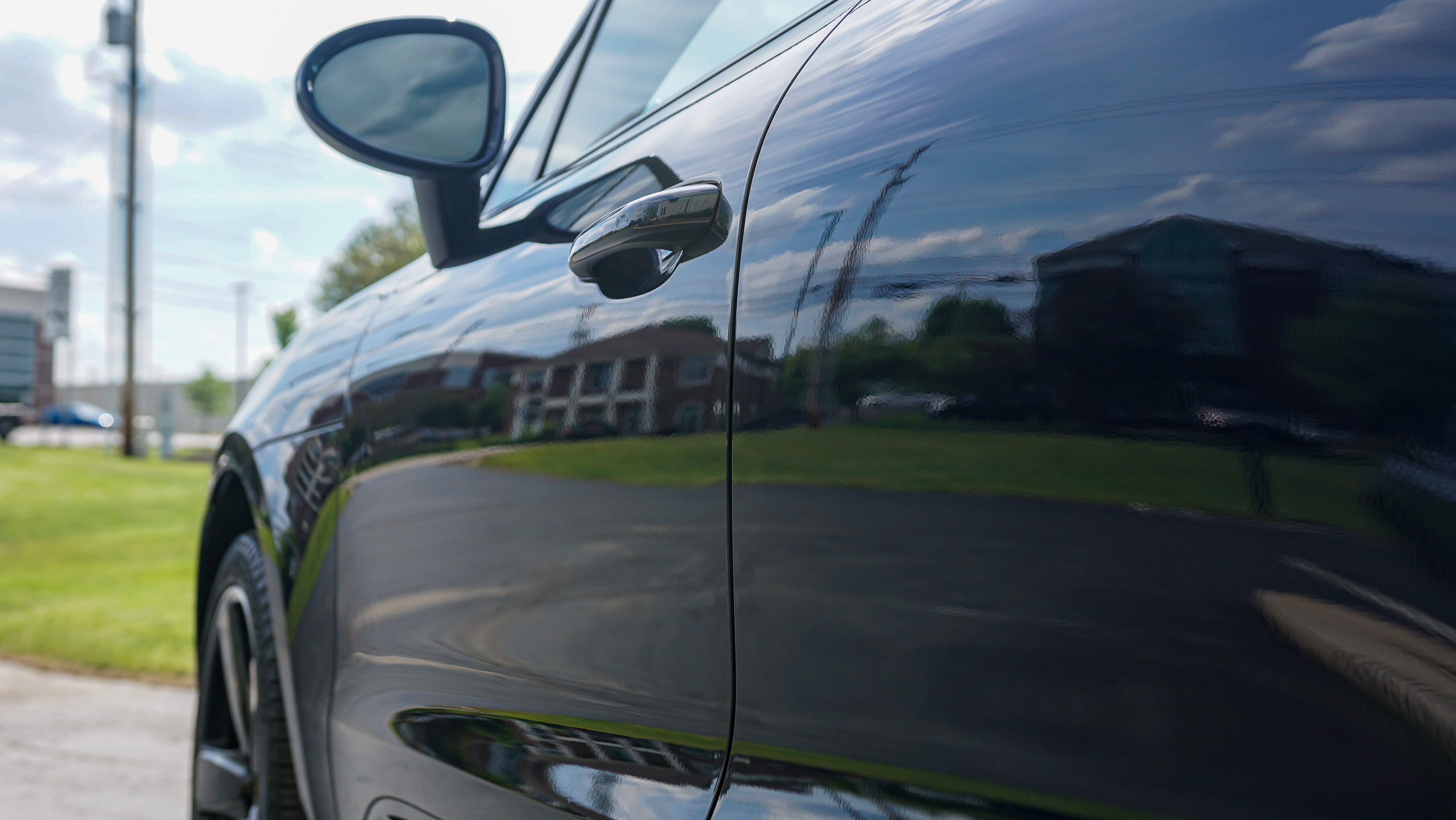 Porsche badge being polished with DA polisher