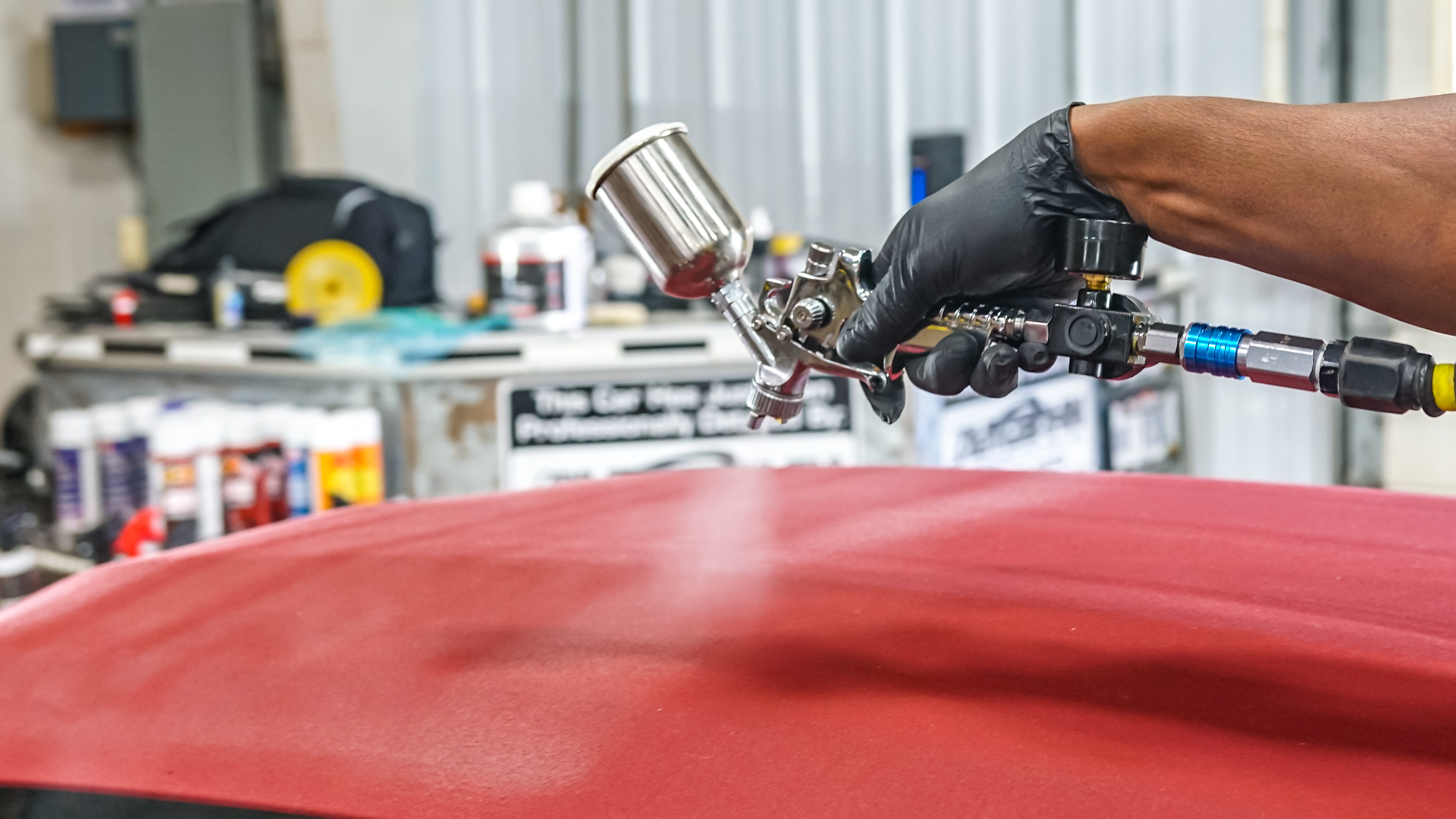 Spray gun applying ceramic coating close-up