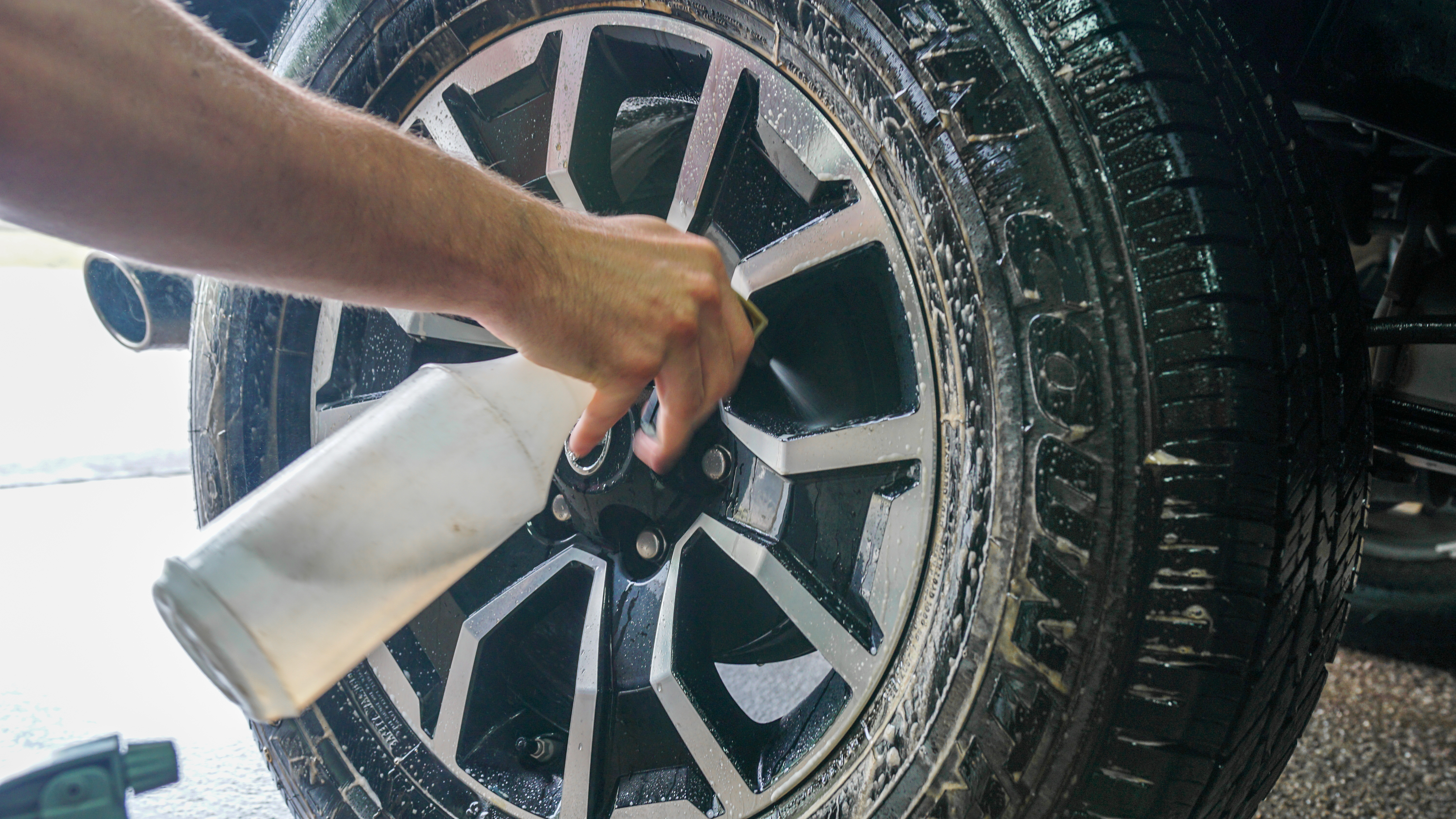 Wheel being cleaned with spray bottle